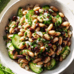 Recipe card with dense bean salad bowl and kitchen prep tools