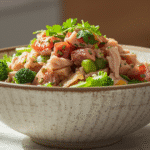 Overhead view of tuna salad with broccoli in a ceramic bowl